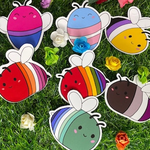 May include: Seven colourful bee-themed stickers with different designs and colours. The bees are all smiling and have different patterns on their bodies. The stickers are perfect for adding a touch of whimsy to any project.