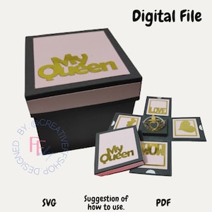 May include: A black and pink explosion box with a gold "My Queen" inscription on the lid. The box opens to reveal a series of smaller boxes with gold inscriptions, including "Love", "My Queen", and "You".