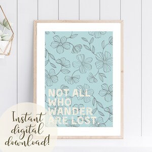 May include: A light blue printable art print with a floral pattern and the text "Not all who wander are lost".