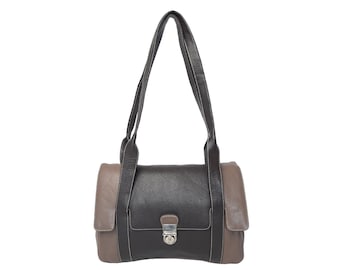 May include: A black and brown leather handbag with a single strap and a silver clasp.