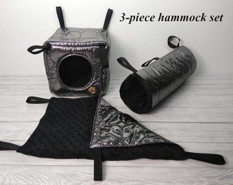 May include: A three-piece hammock set for small pets, featuring a black quilted hanging bed, a black quilted tube, and a black fleece hammock.
