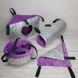May include: A set of four purple and silver pet hanging beds. The beds are made of soft, plush fabric and have a star pattern. The beds are designed for small pets, such as hamsters or gerbils.
