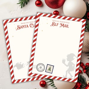 May include: Two sheets of stationery with red and white striped borders. One sheet reads "From the Desk of Santa Claus" and the other reads "Official North Pole Elf Mail". Both have festive illustrations and a cream-colored background.