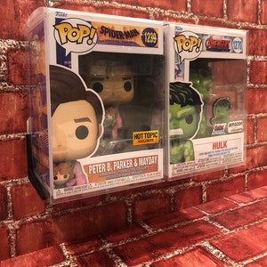 May include: Two Funko Pop! figures in protective plastic cases. The left figure is Peter B. Parker and Mayday from Spider-Man: Across the Spider-Verse, a Hot Topic exclusive. The right figure is Hulk from Avengers: Endgame, an Amazon exclusive.