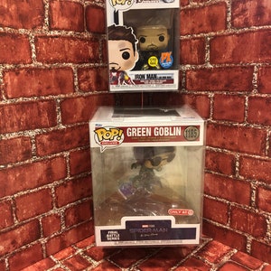 May include: Three Funko Pop! figures in their boxes. The top box features Iron Man from Avengers: Endgame. The middle box features Green Goblin from the Spider-Man: No Way Home movie. The bottom box features Spider-Man from the Spider-Man: No Way Home movie.