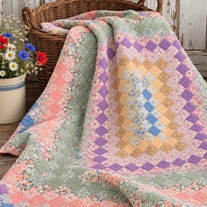 May include: A patchwork quilt featuring a diamond-patterned design in shades of pink, green, purple, blue, and yellow. The quilt is constructed from small fabric squares with floral prints and solid colors, draped over a woven wicker basket.