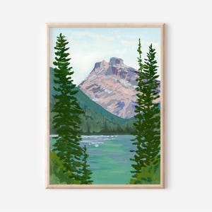 May include: A framed landscape painting depicts a mountain scene. The artwork features a lake in the foreground, with a mountain in the background. Green trees frame the view. The color palette includes shades of green, blue, and pink.