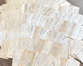 May include: A collection of vintage postcards, arranged in a fan shape. The postcards are aged with a cream color, featuring handwritten text, stamps, and printed details. The postcards are from the U.S. Engineering Service and Postal Card.