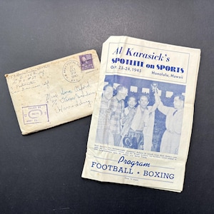 May include: A vintage 1943 Al Karasick's Spotlite on Sports programme from Honolulu, Hawaii, featuring a black and white photo of boxers, alongside a handwritten envelope addressed to Harrodsburg, Kentucky, with a U.S. Army Postal Service stamp.