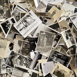 May include: A large pile of black and white photographs, some with people in them, others with landscapes or buildings. The photos are all different sizes and shapes, and they are arranged in a random order.