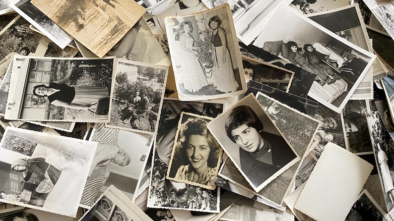 May include: A pile of black and white photographs, some with people in them, others with landscapes or objects. The photos are arranged in a random order, creating a chaotic and nostalgic feel.