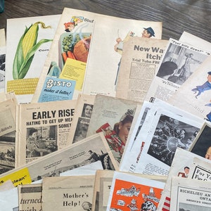May include: A collection of vintage ephemera, including advertisements, newspaper clippings, and magazine pages. The items feature illustrations of food, people, and products, with text in English. The papers are arranged on a wooden surface.