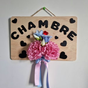 Flowered wooden plate decorated with petunia carnations satin ribbon and message "ROOM"
