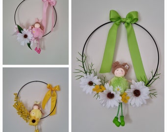 Black metal circle decorated with small fairies yellow pink green with various flowers "LITTLE FAIRIES" ribbon