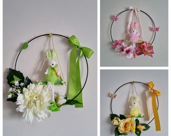 Black metal circle decorated with rabbits on a yellow pink green swings with various flowers ribbons "PETITES BALANCOIRES"