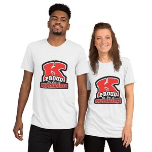 May include: Two white t-shirts with a red and black graphic of a large letter K. The graphic says "Proud to be a Papermaker".