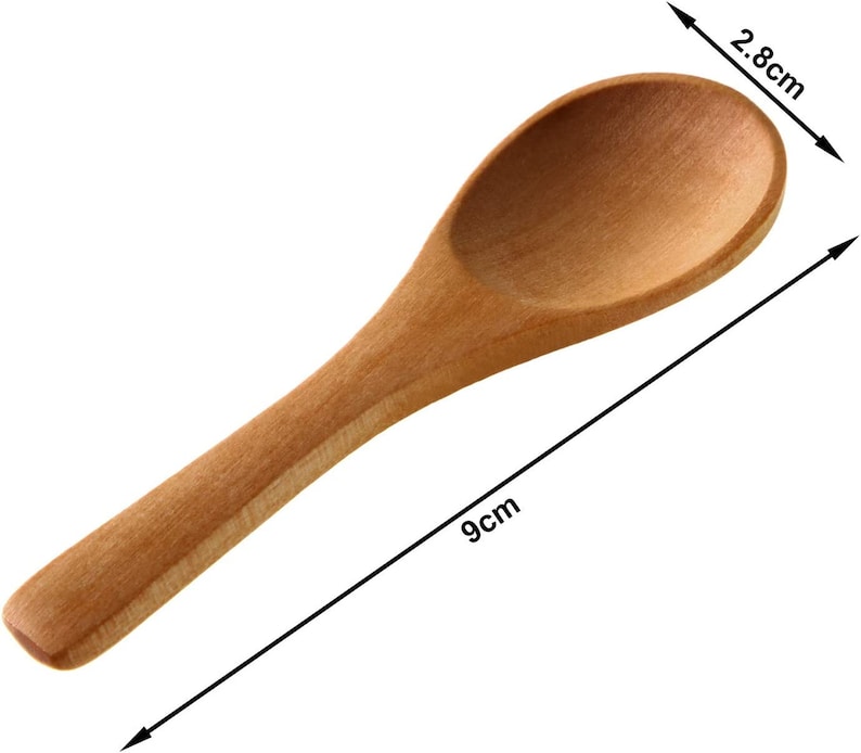 May include: A small, light brown wooden spoon, measuring 9 cm in length and 2.8 cm across the bowl. The spoon features a rounded bowl and a slender handle. The wood grain is visible. Suitable for spices or small servings.