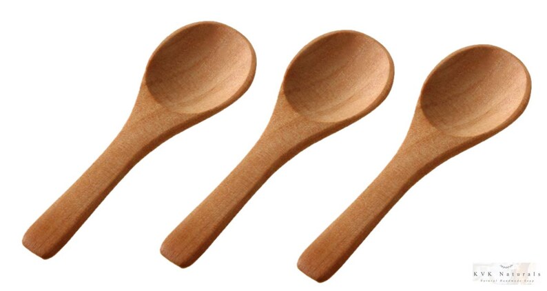 May include: Three wooden spoons with oval bowls and long handles are displayed against a white backdrop. The spoons are made of light-coloured wood and appear unused. The spoons are likely for cooking or serving, each measuring approximately 15 cm in length.