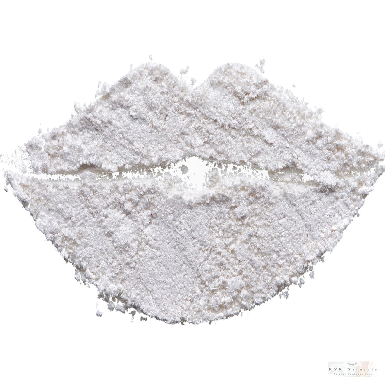 May include: A close-up of a white powder arranged in the shape of lips. The powder has a granular texture and is set against a white background. The bottom right corner of the image has the text "KVK Naturals".