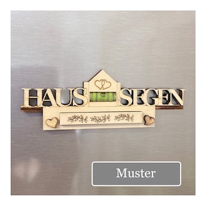 May include: Wooden wall decor with the German words "HAUS SEGEN" and a level. The design includes a house shape with two hearts, a decorative border, and two small hearts. The word "Muster" is in a gray rectangle.