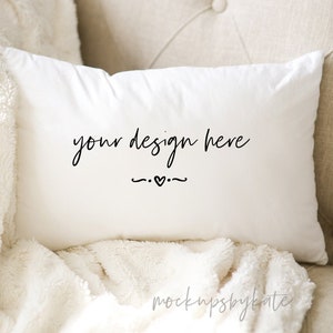 May include: White throw pillow with the text "your design here" in black cursive font with a small heart symbol.