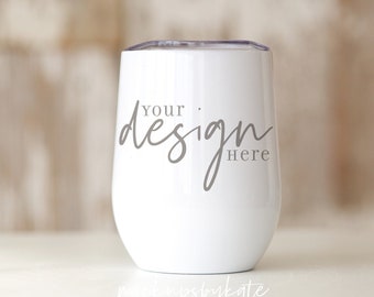 May include: White stainless steel tumbler with a clear lid. The tumbler has the text "Your design here" printed on the side.