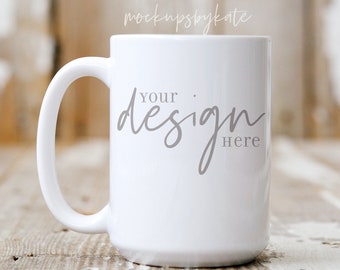 May include: White ceramic mug with a handle. The mug has the text "Your design here" printed on the front in a gray script font.