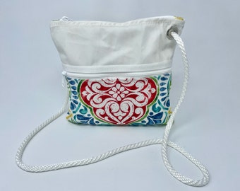 Recycled sailcloth cross-body purse 9 1/2" H x 10" W, zippered main compartment + 3 external  pockets, accent fabric,