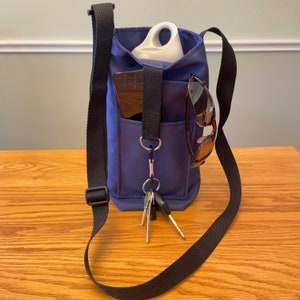 Water bottle tote with 2 external pockets,  crossbody strap, built in keyring holder, carabiner.  Hikes/Dog walks/Fitness/Birding/Travel