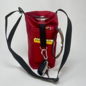 Water bottle tote with 2 external pockets,  crossbody strap, built in keyring holder, carabiner.  Hikes/Dog walks/Fitness/Birding/Travel
