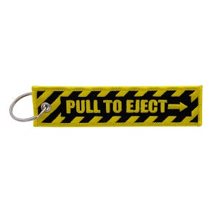 May include: A yellow and black striped key chain with the text "PULL TO EJECT" and a black arrow pointing to the right.