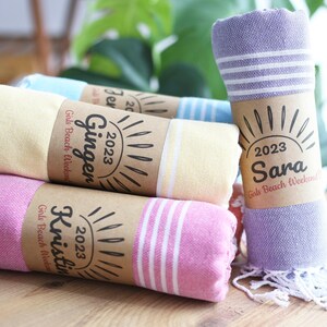 Wedding gift beach towels decorated with my bridesmaids' names on elegant paper wrappers