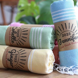 Wedding gift beach towels decorated with my bridesmaids' names on elegant paper wrappers