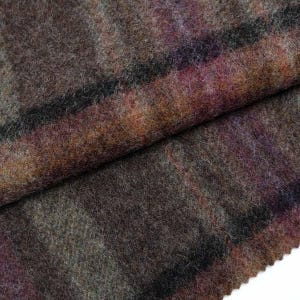 May include: Close-up of a soft, fuzzy fabric with a plaid pattern in shades of brown, purple, and gray.