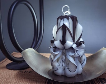Black and white carved candles in three sizes.