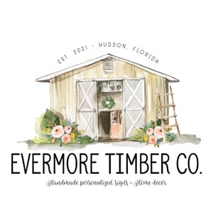 May include: A watercolor illustration of a yellow barn with a wooden door and a wreath on it. The barn is surrounded by flowers and a ladder. The text "EVERMORE TIMBER CO." is below the barn, and the text "Handmade personalized signs - Home decor" is below that.