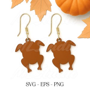 May include: A pair of brown turkey-shaped earrings with gold-colored ear wires. The earrings are a Thanksgiving-themed accessory. The image also includes fall leaves and a pumpkin.