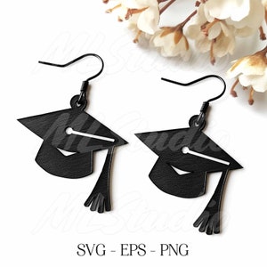 May include: A pair of black graduation cap earrings. The earrings are made of metal and have a black finish. The graduation caps are detailed with a tassel and a small circle on the top.