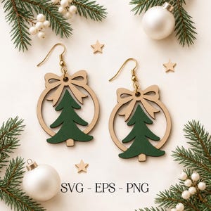 May include: A pair of wooden dangle earrings featuring a circular frame with a bow at the top and a green Christmas tree cutout in the center. The earrings have gold-toned metal hooks. The text SVG - EPS - PNG is printed at the bottom.