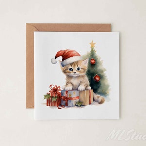 May include: A Christmas card featuring a cute kitten wearing a Santa hat and sitting on a stack of presents in front of a Christmas tree.