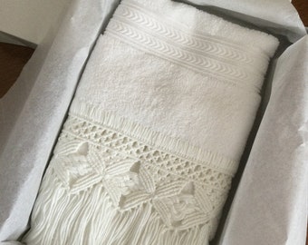 May include: A white bath towel with a crocheted fringe border. The towel is folded and placed in a white tissue paper-lined gift box.