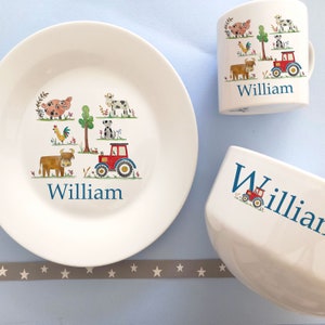 May include: A white ceramic plate featuring a red tractor, a cow, a pig, a rooster, and a dog. The plate is personalised with the name "William" in blue.