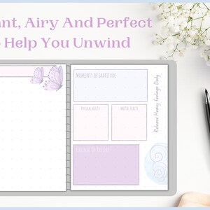 May include: A light purple and blue daily planner with a dotted background. The planner has sections for "Date", "Moments of Gratitude", "Physical Health", "Mental Health", and "Release Heavy Feelings Daily". The planner also features butterflies and swirls.
