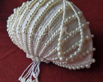 Shell-shaped bridal handbag. Wedding accessory with lace and pearl beads. A couture women’s bag