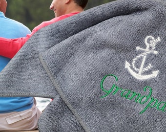 May include: Gray beach towel with a white anchor and green embroidered text that says "Grandpa".