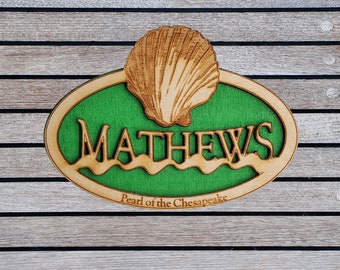 Mathews Virginia Wood Magnet featuring an Oyster Shell or Scallop