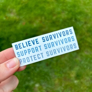May include: A white sticker with blue text that reads "Believe Survivors, Support Survivors, Protect Survivors".
