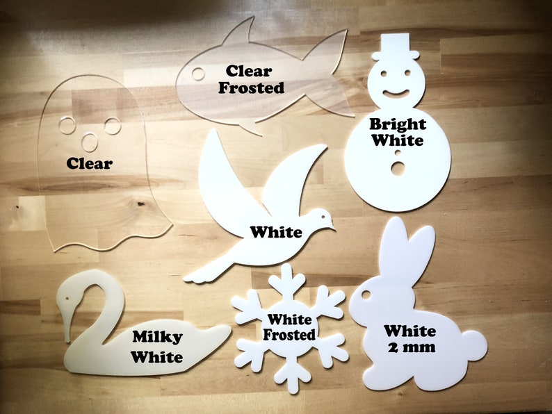 May include: A collection of laser-cut acrylic shapes in various colors and finishes. Includes a clear ghost, a clear frosted fish, a white dove, a bright white snowman, a milky white swan, a white frosted snowflake, and a white 2 mm rabbit.