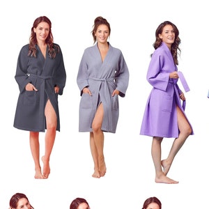 May include: Ten women's robes in various colors, including black, burgundy, gray, lavender, pink, blue, and white. The robes are all long-sleeved and have a tie belt.