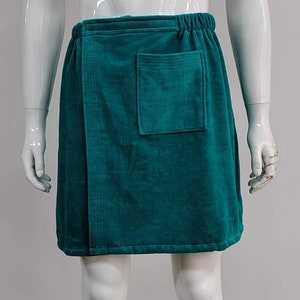 May include: A teal blue terry cloth wrap skirt with a single pocket on the front.